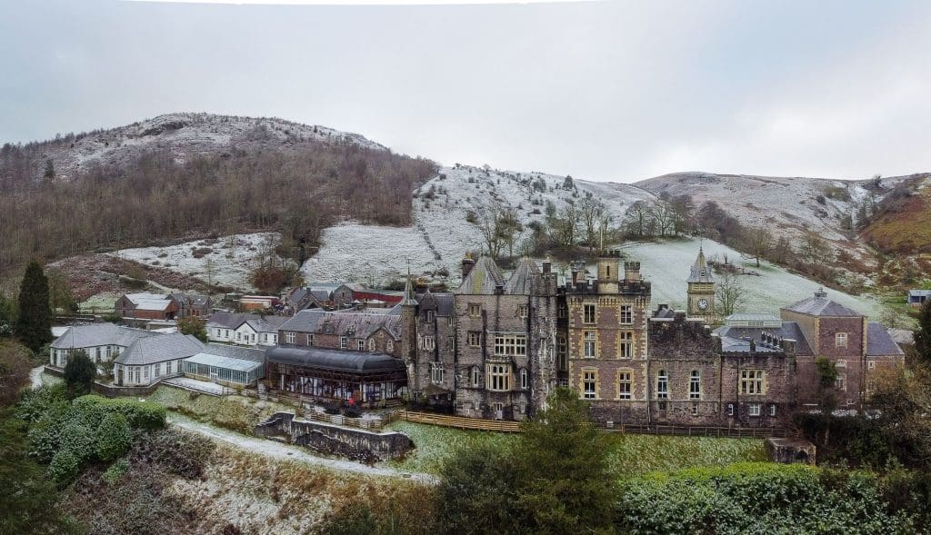craig y nos castle wedding venue. view from the rear of the castle from a drone.