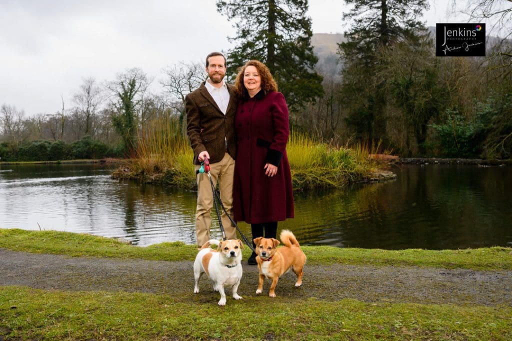 pre-wedding photoshoot at Craig Y Nos Country park couple with 2 dogs by lake